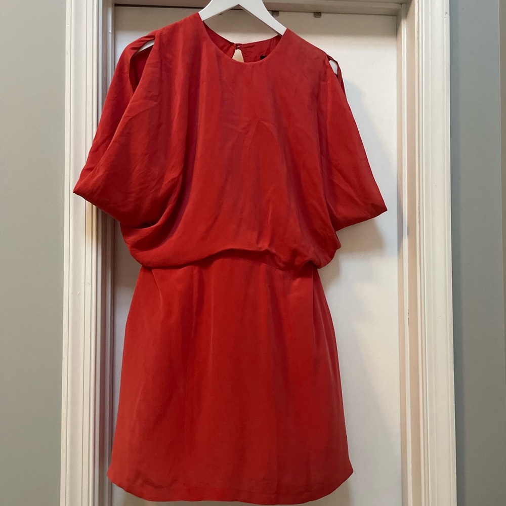 Dark pink loose fitting dress with open back and button detail.